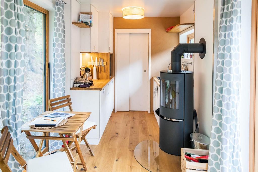 a small kitchen with a stove in a tiny house at WOHNWAGON Tiny Houses I in Gutenstein