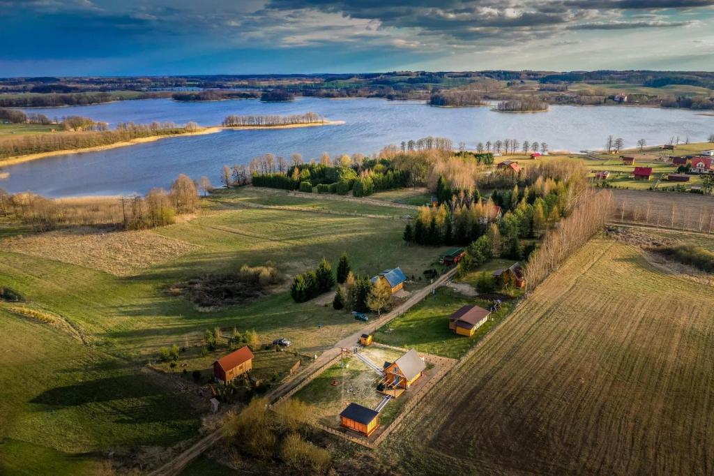 an aerial view of a farm and a river at Nini House Giże in Giże