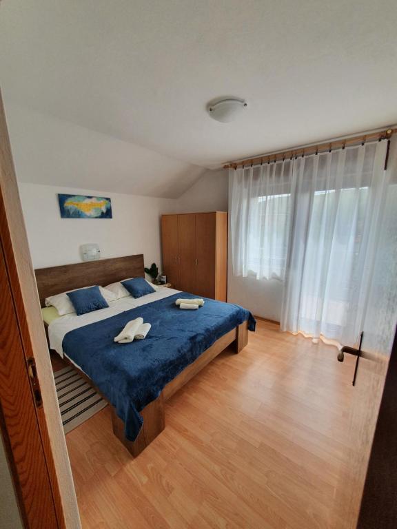 a bedroom with a bed with two towels on it at Apartment Selak in Šibenik