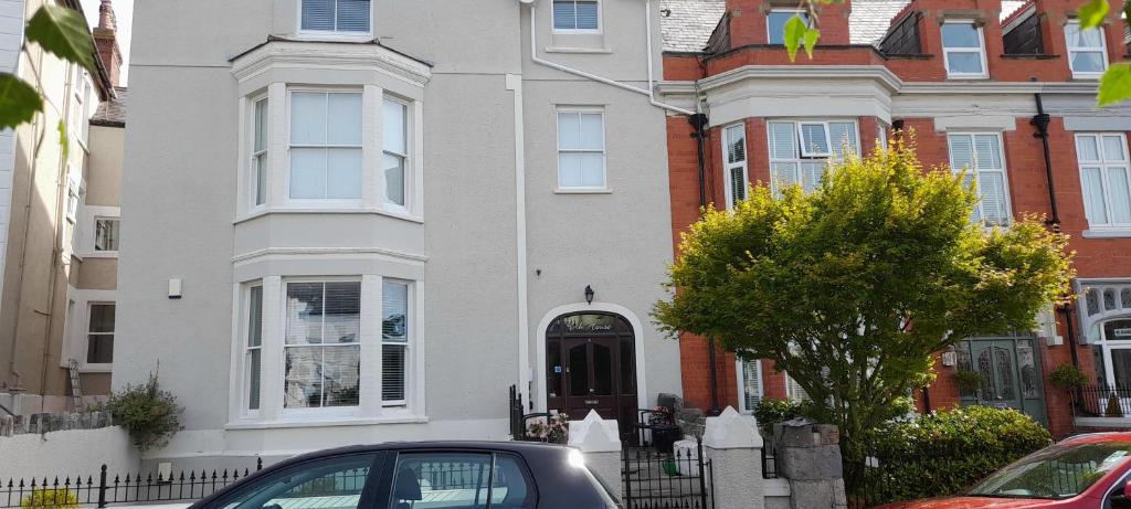 a house with a car parked in front of it at Modern 2nd floor 1 bed apartment in the heart of in Llandudno