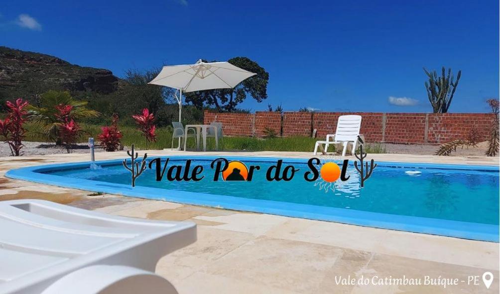 a swimming pool with a sign that says wake up doctors at Chácara Vale Por do Sol in Catimbau