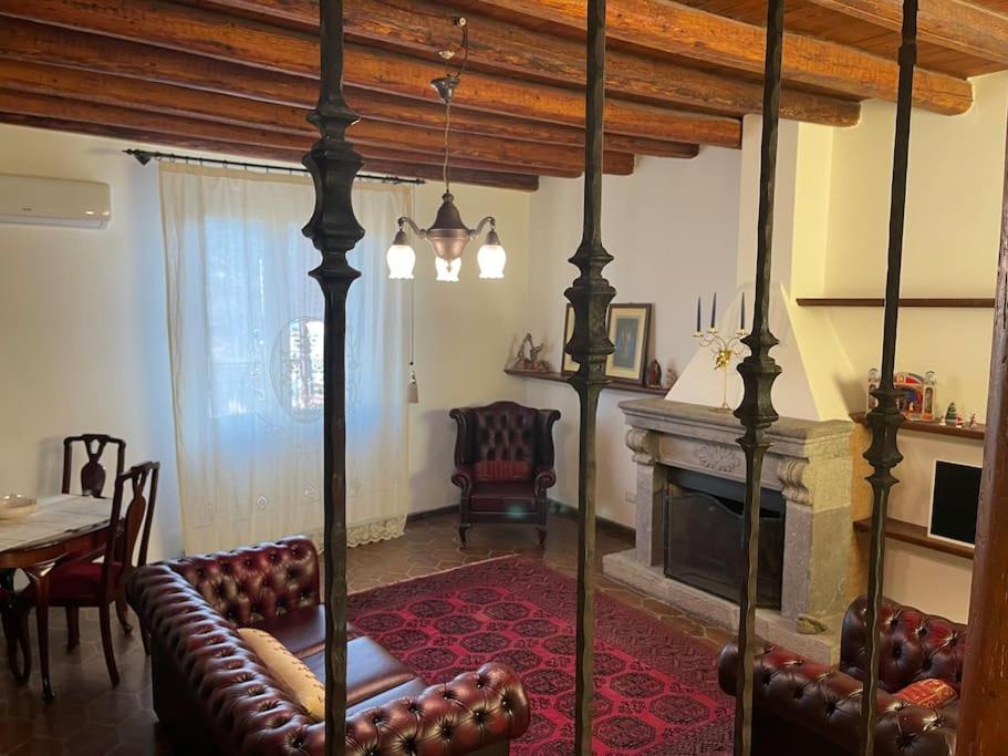 a living room with a couch and a fireplace at Casa Al Plumbago in Termini Imerese