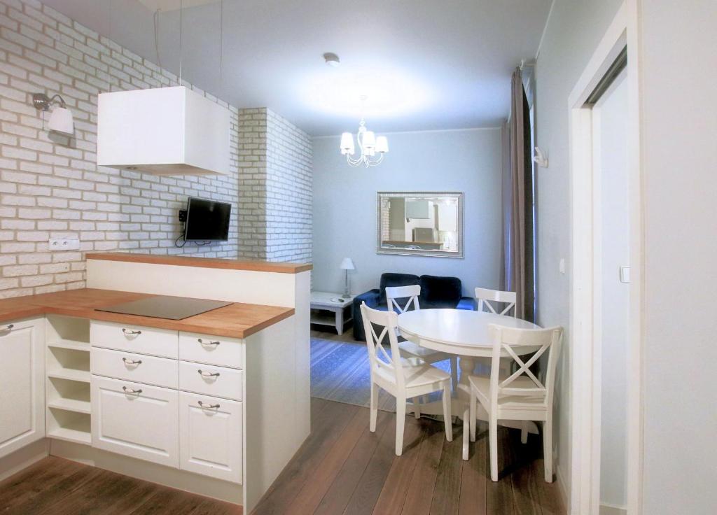 a kitchen and dining room with a table and a dining room at Old Town Apartment in Krakow