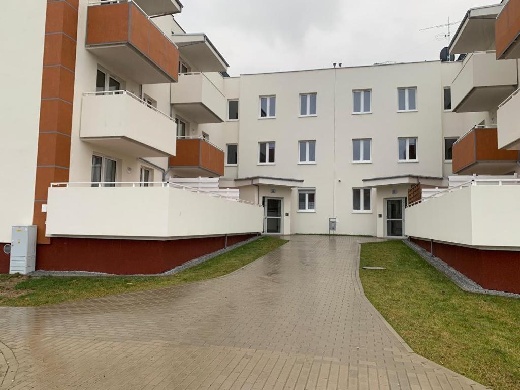 an empty courtyard of a large building at Apartament - Brzeska For You in Lubin
