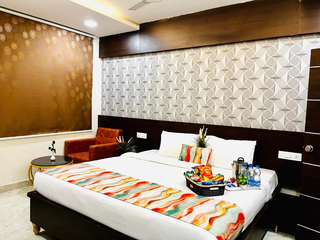 a bedroom with a large bed and a chair at Hotel Park Airport Zone Hyderabad in Shamshabad
