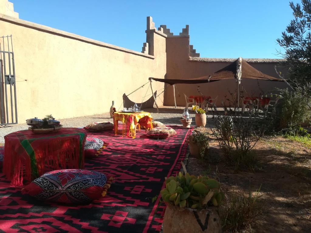 a blanket with a fire in front of a house at Gite Amoudou in Ouarzazate