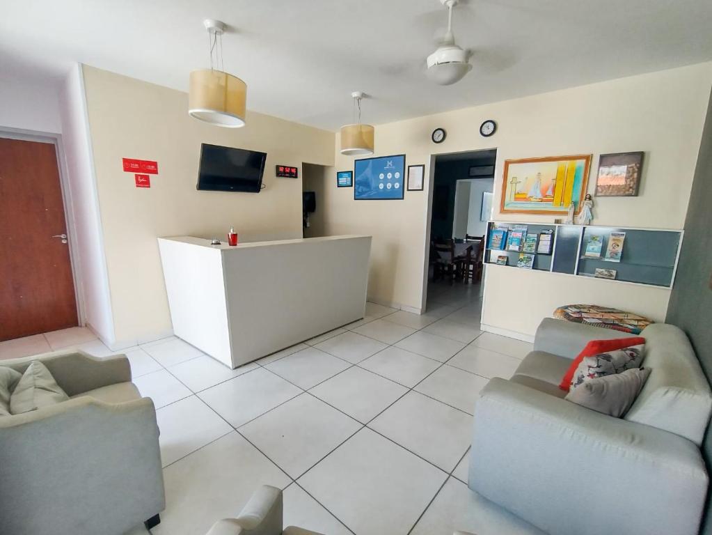 a waiting room with two couches and a counter at Pousada Maceio Paradise in Maceió