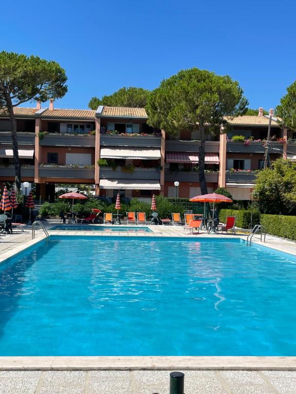 a large swimming pool in front of a building at Summer House - Appartamento fronte mare in Marcelli