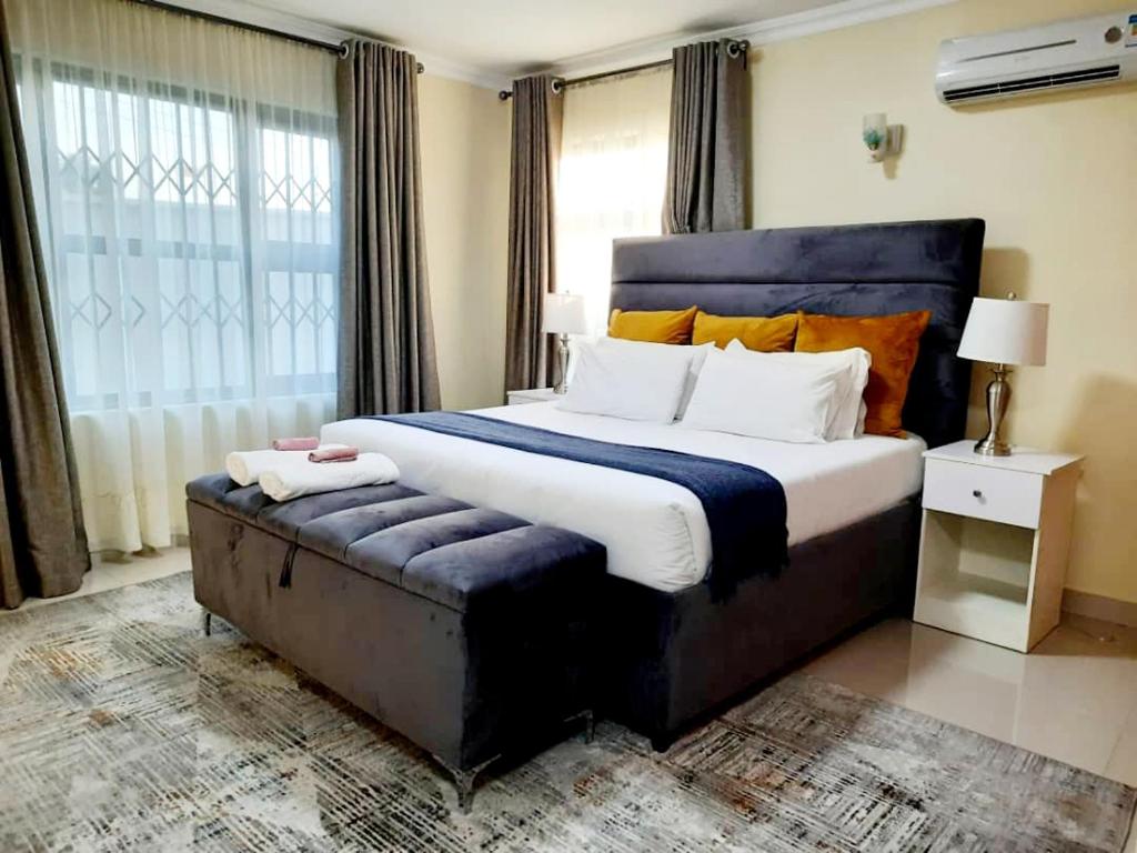 a bedroom with a large bed and a large window at InstaHomes by Tru - Villa in Blantyre