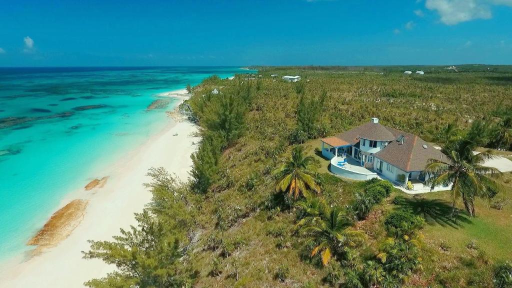 an aerial view of a house on a beach at Tourmaline home in Governorʼs Harbour