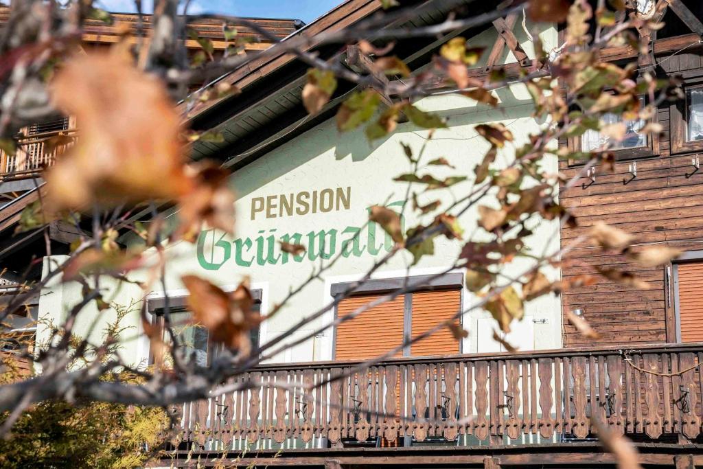 a building with a sign on the side of it at Pension Grünwald in Sölden