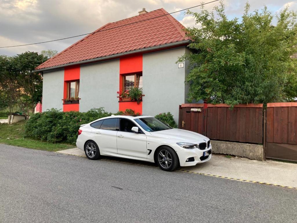 a white car parked in front of a house at Ubytovanie u Katky in Bobrovec