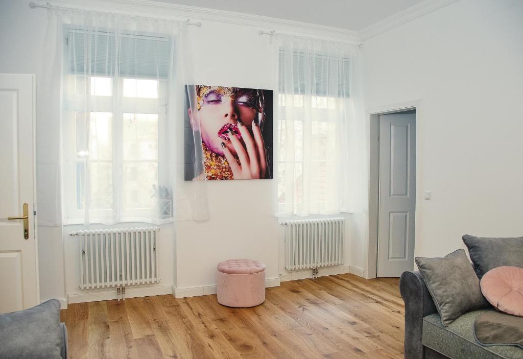 a living room with a picture of a woman on the wall at Pink Lotus Apartment in Vienna