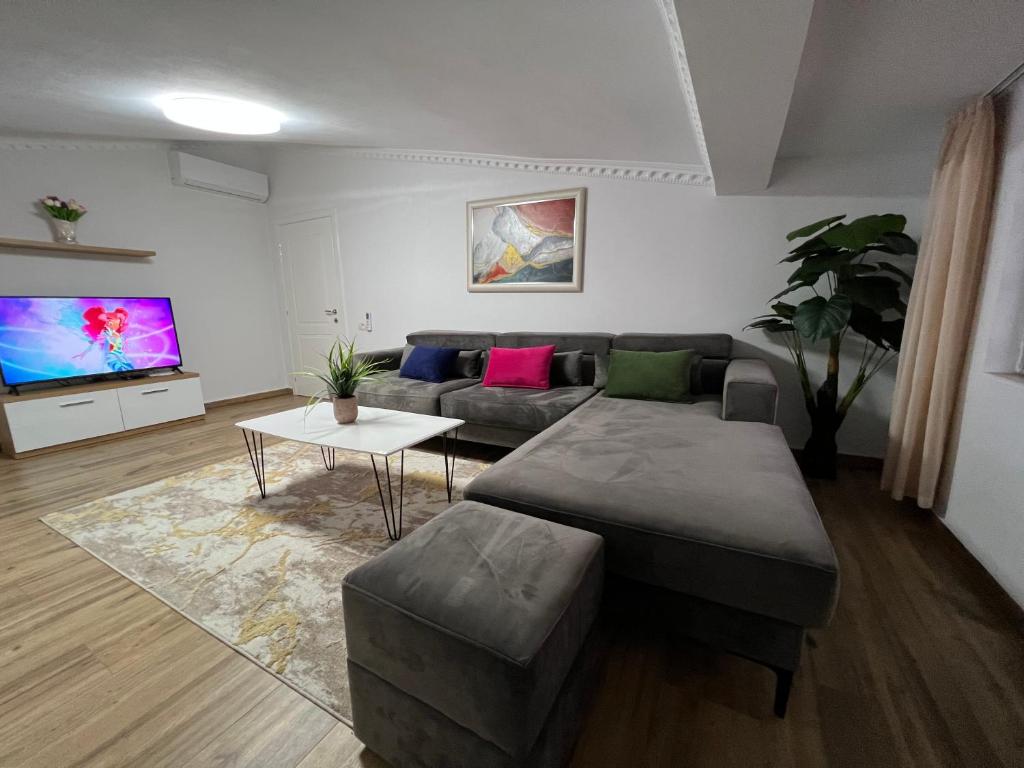 sala de estar con sofá y TV en House Elbasan city center 3, en Elbasan