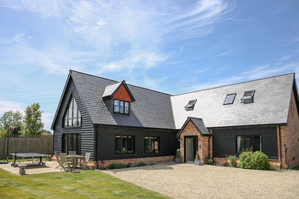 a large house with a gambrel roof at Hurstpierpoint 3 bedroom House with Hot-Tub & Garden in West Sussex in Hurstpierpoint