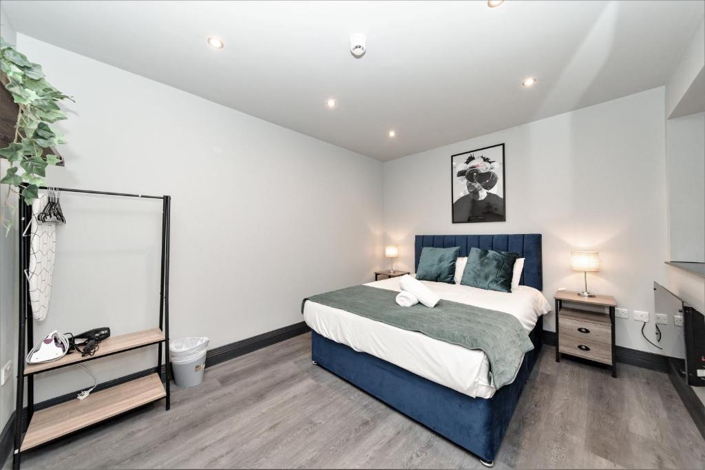 a bedroom with a large bed and a mirror at King Size Bed Super Morden One Bedroom Flat next to Seafront in Brighton & Hove