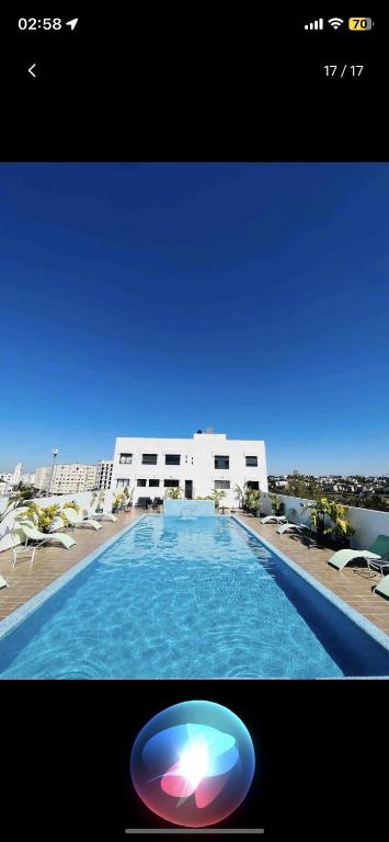 a swimming pool with a frisbee in front of a building at Superbe & tendance, proche de toutes commodités in Casablanca