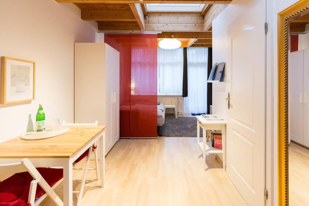 a room with a table and a desk with a computer at Apartment Wilhelmstr für bis zu 3 Personen in Brühl