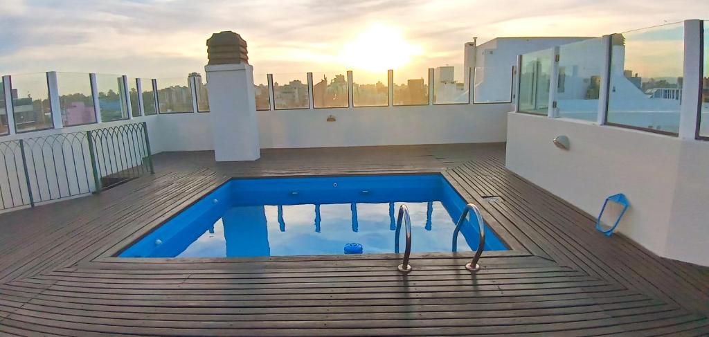 a swimming pool on the roof of a building with a lighthouse at El Rincon de Mia in Córdoba