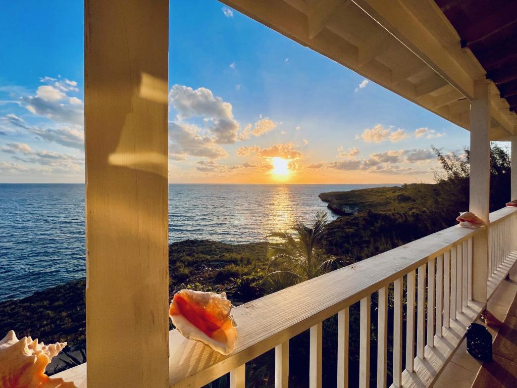 a view of the ocean from the balcony of a house at Blue Love Point 3BR home in Gregory Town