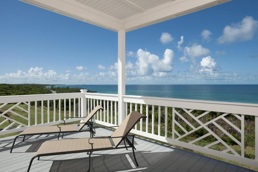 a porch with chairs and a view of the ocean at Buttonwood Reserve Two Entire Building Duplex in James Cistern