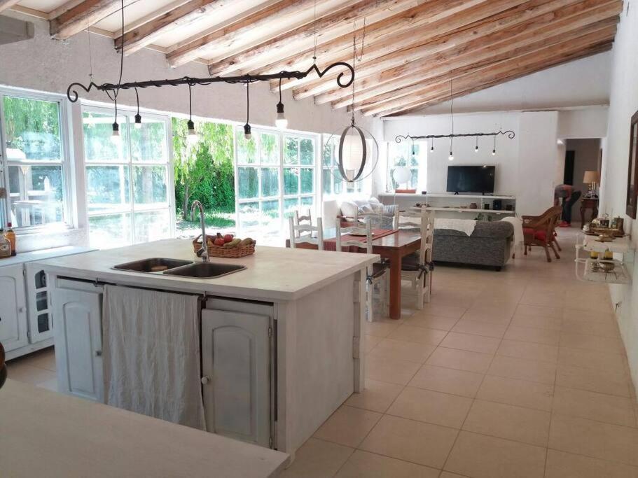 a kitchen and living room with a kitchen island and a living room at Casa Ramal in Ciudad Lujan de Cuyo