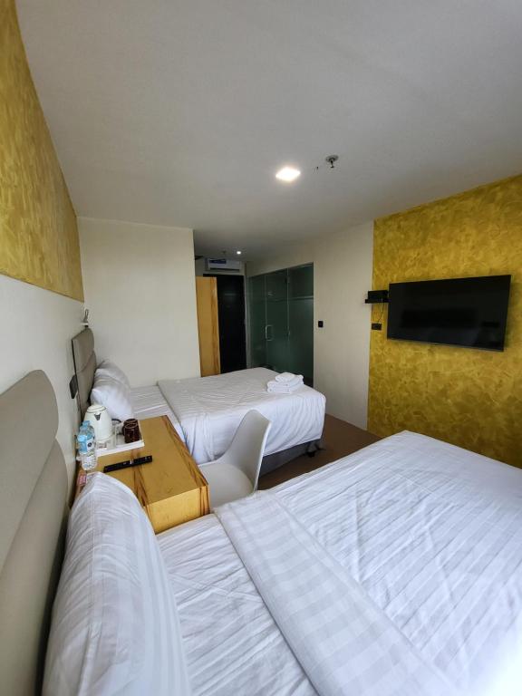 Cama o camas de una habitación en Sempre Premier Inn - MACTAN AIRPORT HOTEL