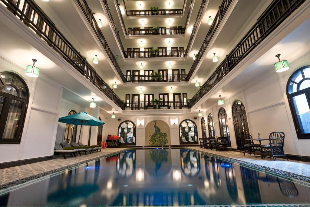 a large swimming pool in a building with a ceiling at Hoi An Delicacy Hotel & Spa in Hoi An