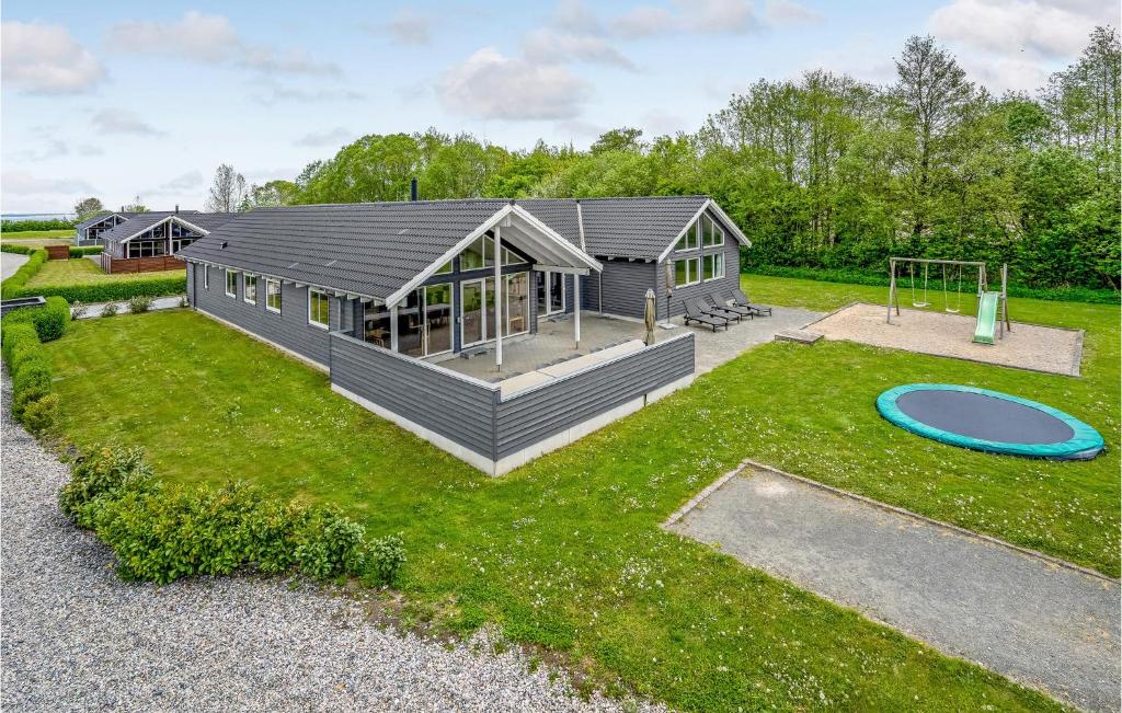 a large house with a playground in the yard at Cozy Home In Nordborg With Kitchen in Nordborg