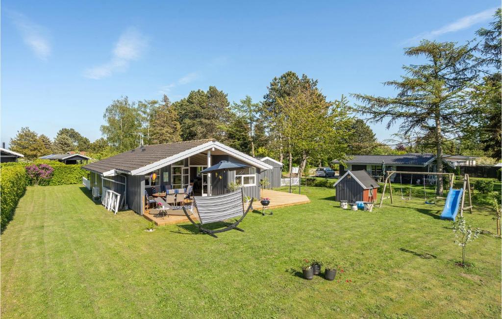 a large yard with a house and a playground at Stunning Home In Bog By With Sauna in Bogø By