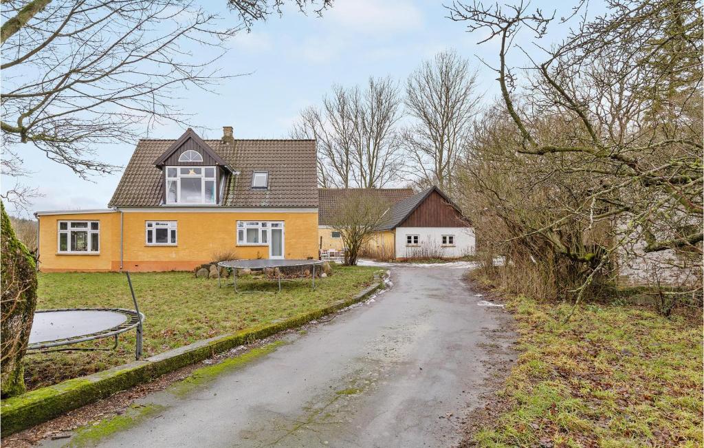 a house with a dirt road in front of it at 3 Bedroom Gorgeous Apartment In Klemensker in Klemensker