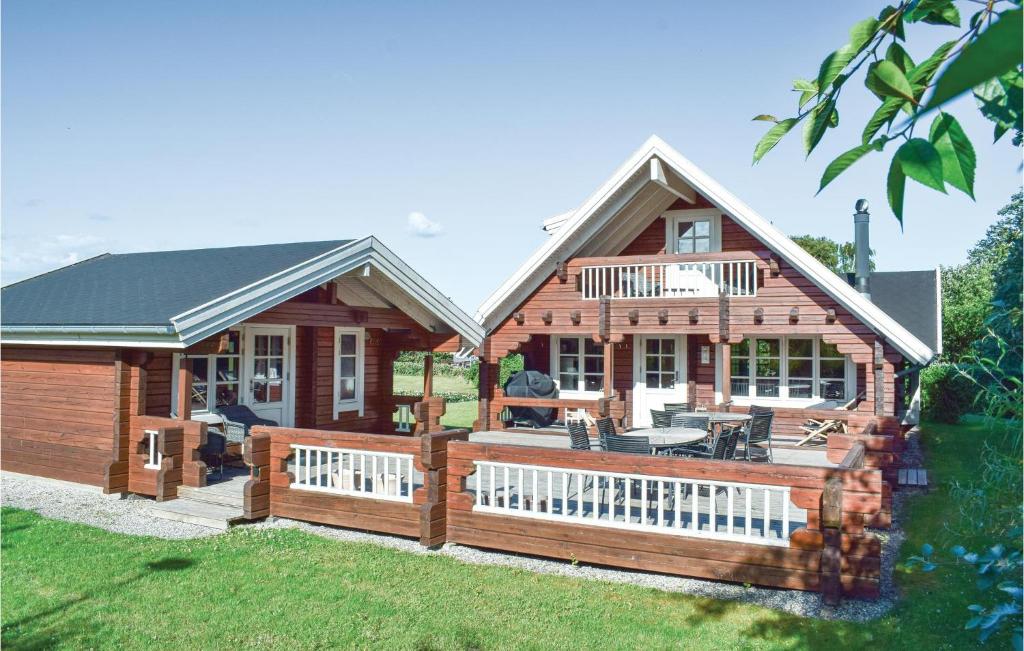 ein großes Holzhaus mit einer großen Terrasse in der Unterkunft Amazing Home In Humble With Sauna in Humble