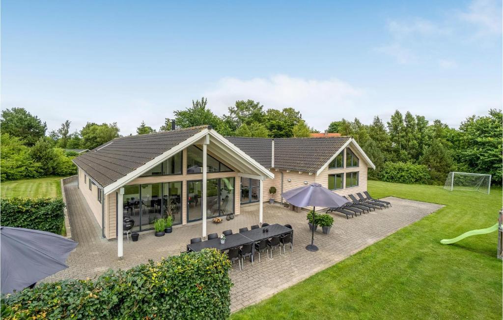 a pavilion with tables and chairs and umbrellas at Nice Home In Tisvildeleje With Private Swimming Pool, Can Be Inside Or Outside in Holløselund