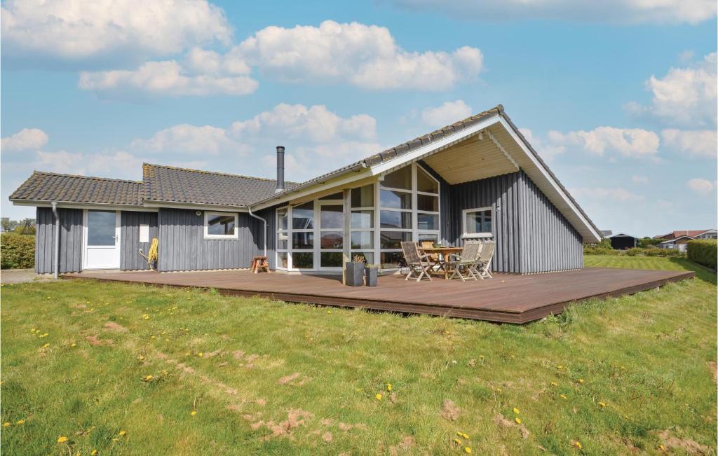 een huis met een groot houten terras in een veld bij Stunning Home In Vinderup With Kitchen in Vinderup