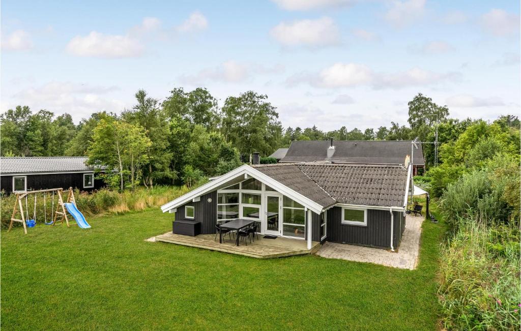 a house with a large yard with a playground at Awesome Home In Hadsund With Sauna in Hadsund