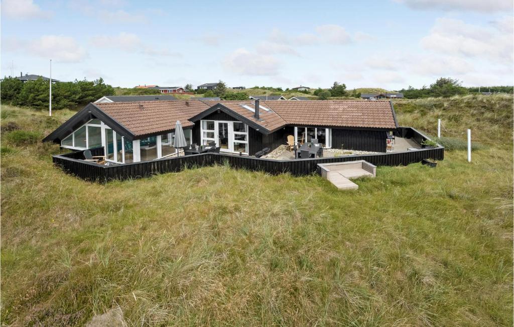 dom na polu trawy w obiekcie Cozy Home In Vejers Strand With Outdoor Swimming Pool w mieście Vejers Strand