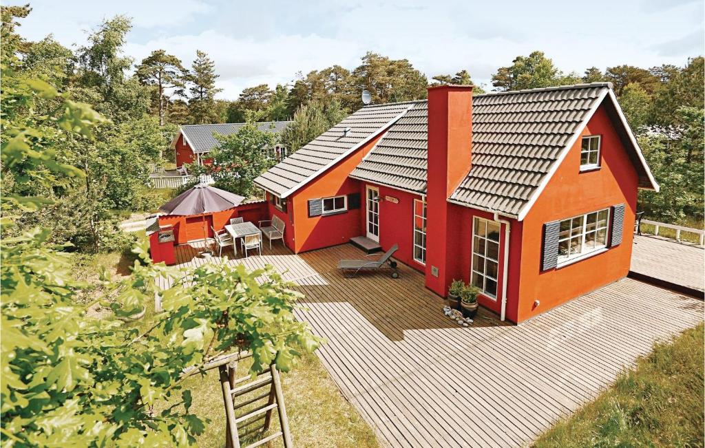 an aerial view of a red house with a deck at Tefres in Snogebæk