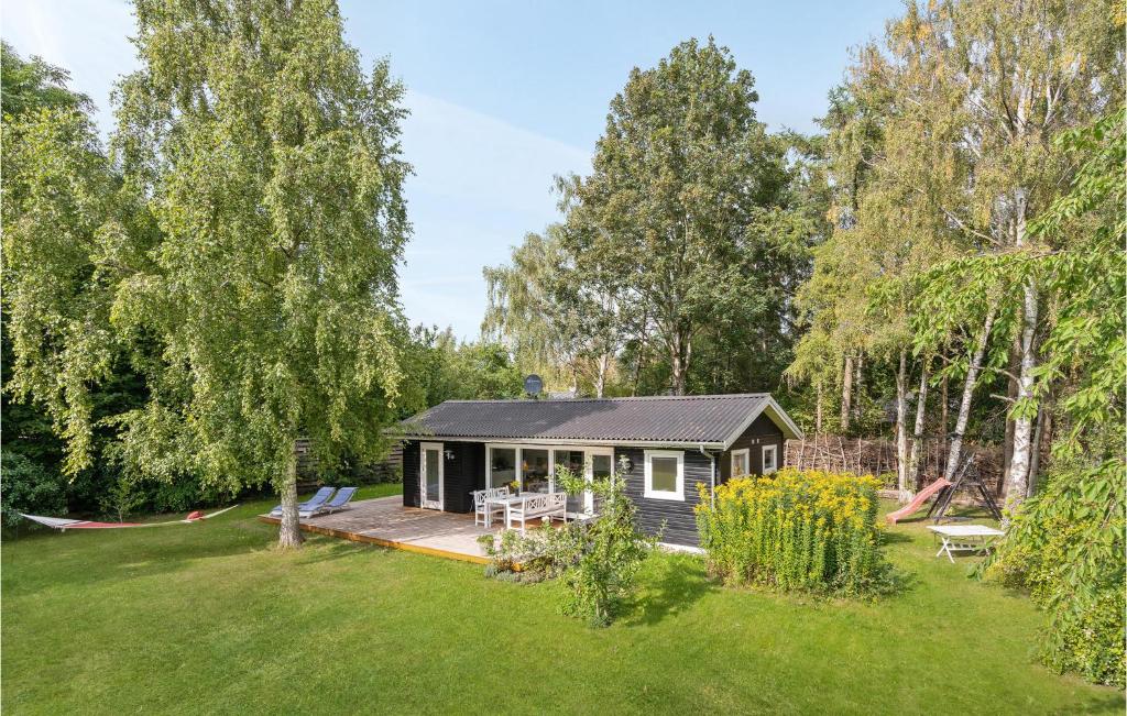 a small house with a deck in a yard at Beautiful Home In Kirke Hyllinge With 2 Bedrooms And Wifi in Kirke-Hyllinge