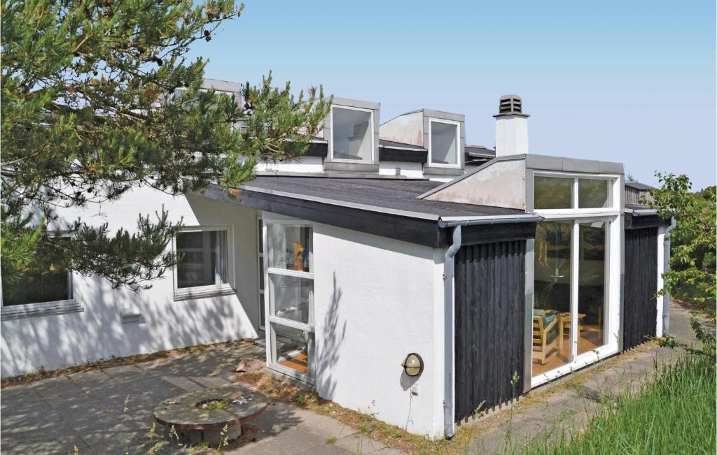 a white house with a black roof at Lovely Home In Hirtshals With Indoor Swimming Pool in Hirtshals