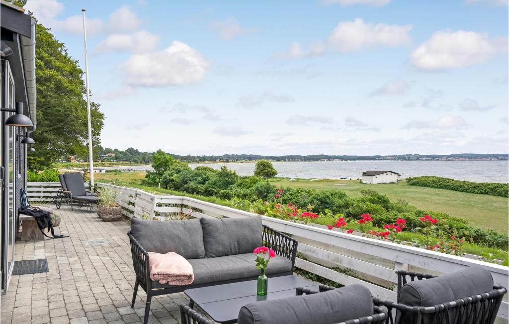 a patio with a view of the water at Two-Bedroom Holiday Home In Ebeltoft in Ebeltoft