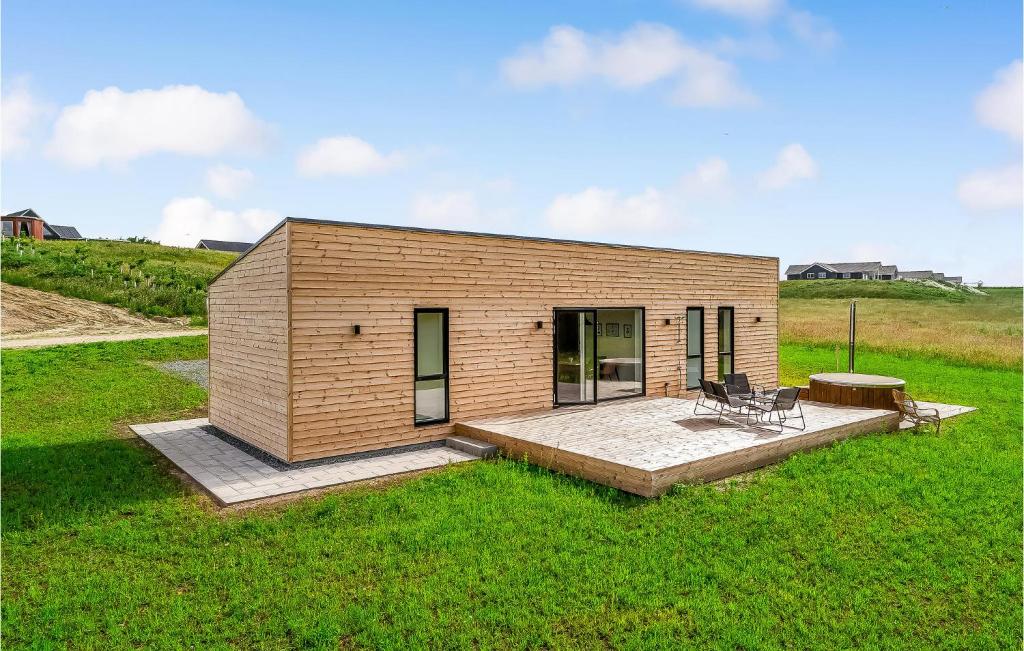 a small wooden house in the middle of a field at Amazing Home In Spttrup With Wifi in Lihme
