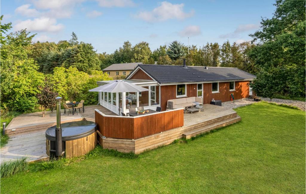 a house with a deck and a hot tub at Nice Home In Havndal With Kitchen in Havndal
