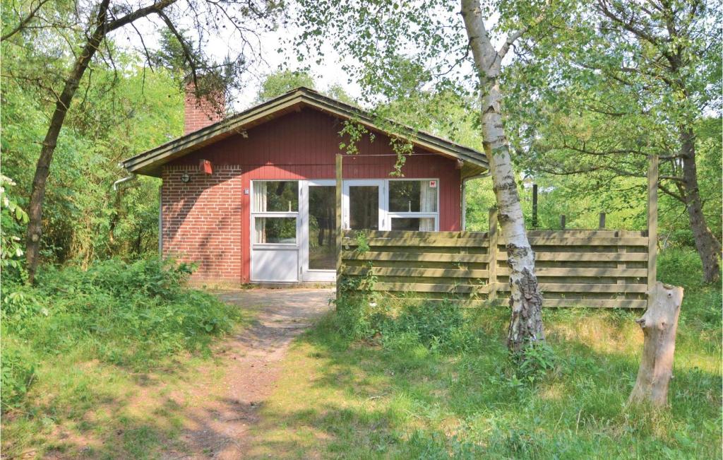 een klein rood bakstenen huis met een witte deur bij Beautiful Home In Fan With Wifi in Fanø