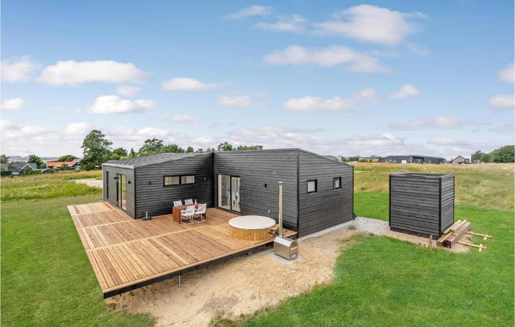 a black tiny house on a wooden deck at 4 Bedroom Gorgeous Home In Lgstrup in Løgstrup
