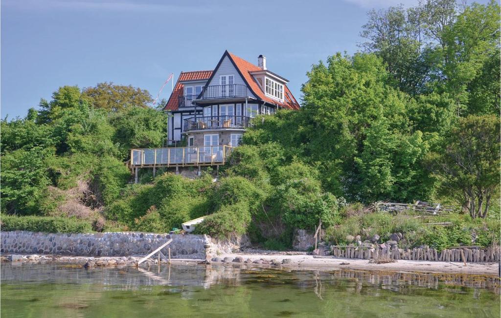 a large house on top of a hill next to the water at Cozy Apartment In Faaborg With Wifi in Fåborg