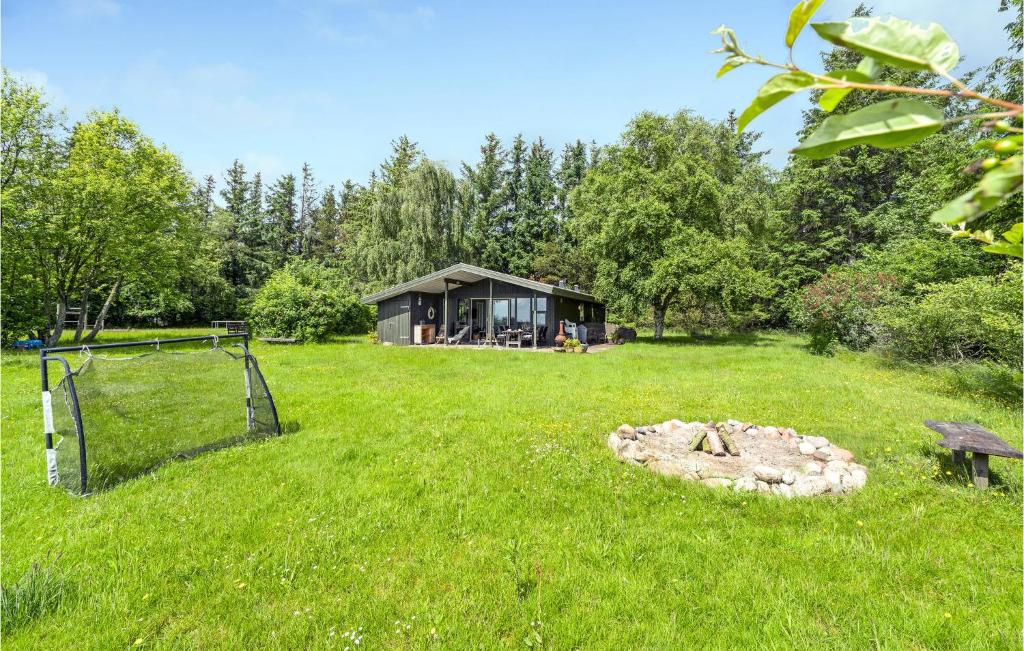 a cabin in the middle of a grass field at Amazing Home In Spttrup With House Sea View in Spottrup