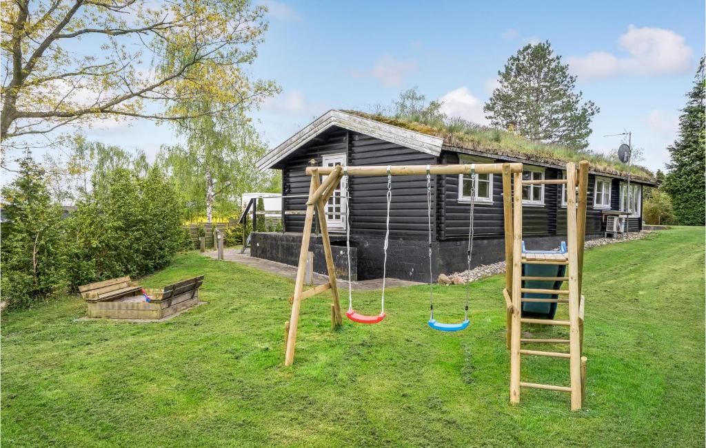 a playground with a ladder and a house at 2 Bedroom Lovely Home In Jgerspris in Hornsved