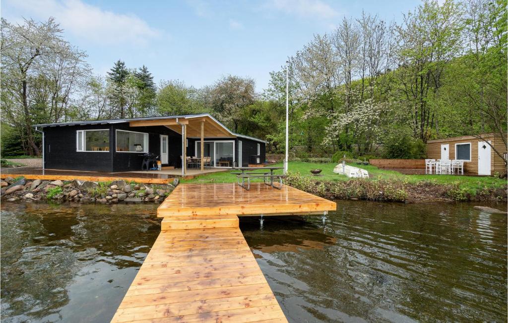 a house on the water with a dock at Lovely Home In Silkeborg With Wifi in Silkeborg