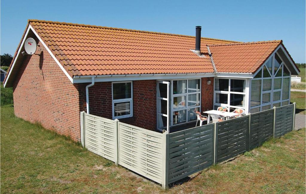 a house with an orange roof with a deck at Gorgeous Home In Hvide Sande With Ethernet Internet in Havrvig