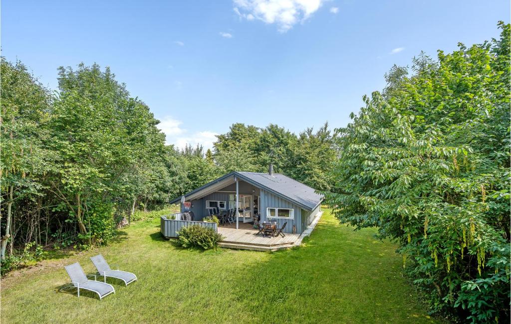 a tiny house in the middle of a yard at Four-Bedroom Holiday Home In Dronningmolle in Dronningmølle